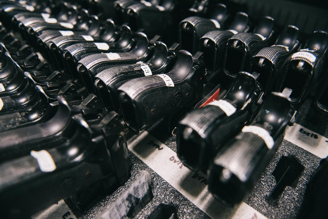 M9 pistols sit in an armory cabinet at Joint Base Andrews, Md., June 12, 2017. In addition to storing M4 carbines, M9 pistols, M249 light machine guns, and stored weapons for transient personnel, the armory also stores radios, pepper spray, tactical expandable batons and other items. (U.S. Air Force photo by Senior Airman Delano Scott). 