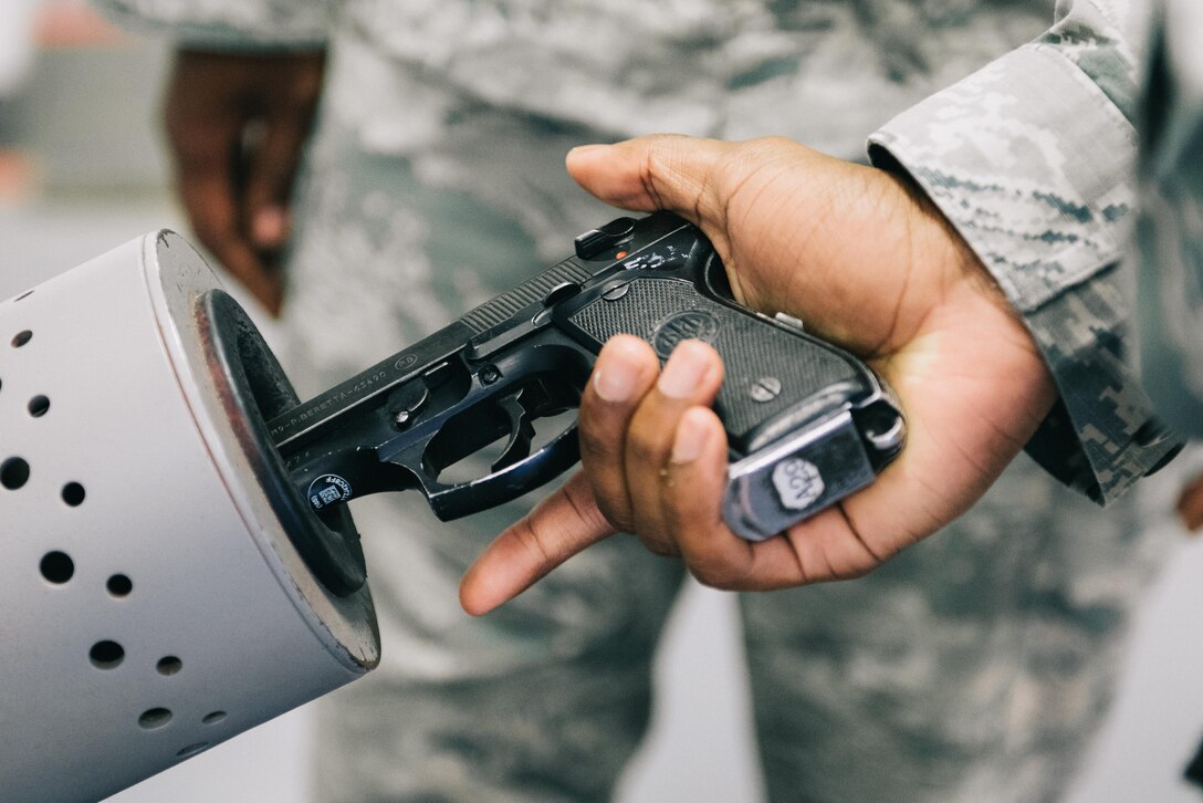 Tech. Sgt. Derrick Terrell, 11th Security Support Squadron armory NCO in charge, clears an M9 pistol at Joint Base Andrews, Md., June 12, 2017. In addition to storing and maintaining weapons, armorers equip security forces Airmen with necessary weapons and ammunition to effectively protect the base. (U.S. Air Force photo by Senior Airman Delano Scott)