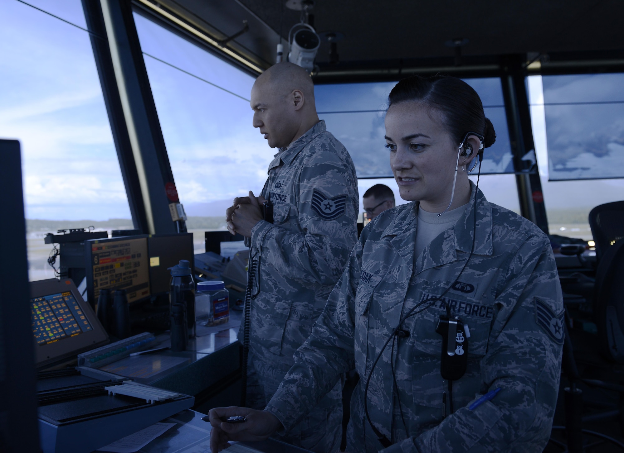 U.S. Air Force Staff Sgt. Amanda Ahsoak, air traffic control journeyman, and Tech. Sgt. Jason McLean, air traffic control tower watch supervisor, give direction to an inbound aircraft, Joint Base Elmendorf-Richardson, Alaska, June 15, 2017. ATC Airmen are responsible for the safety and control of hundreds of military and civilian aircraft every day. 