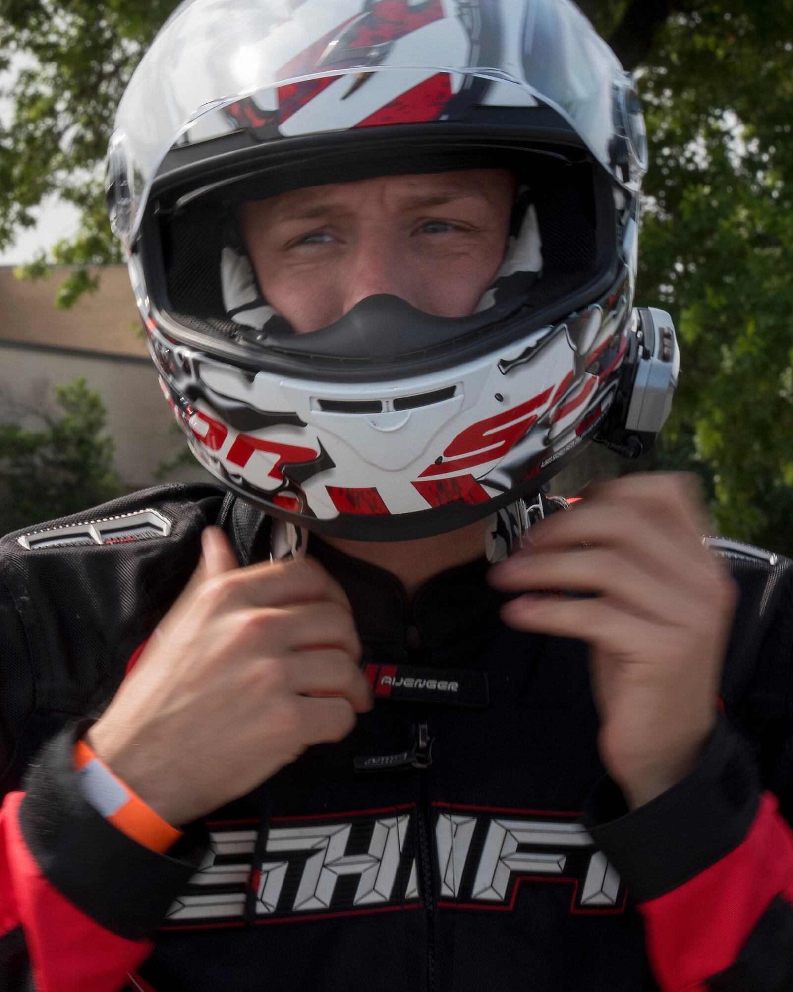 A motorcyclist puts on their helmet during the Seventh Annual Motorcycle Safety Day at Joint Base Andrews, Md., June 15, 2017. The event featured vendors, local clubs, food, motorcycle safety demonstrations, a police-escorted off-base ride and prize giveaways. (U.S. Air Force photo by Airman 1st Class Valentina Lopez)