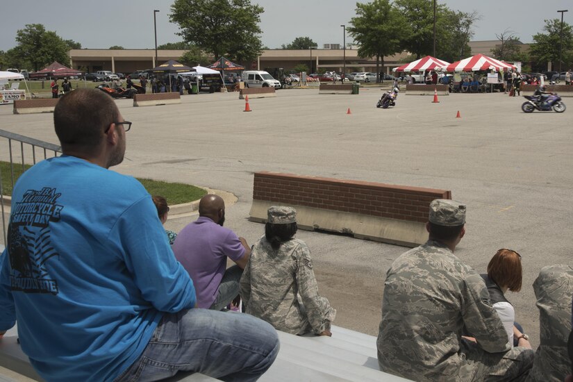 Motorcycle safety day attendees watch a motorcycle demonstration during the Seventh Annual Motorcycle Safety Day at Joint Base Andrews, Md., June 15, 2017. The demonstration, performed by professional motorcycle racers, displayed safety maneuvers to conduct during a race. (U.S. Air Force photo by Airman 1st Class Valentina Lopez)