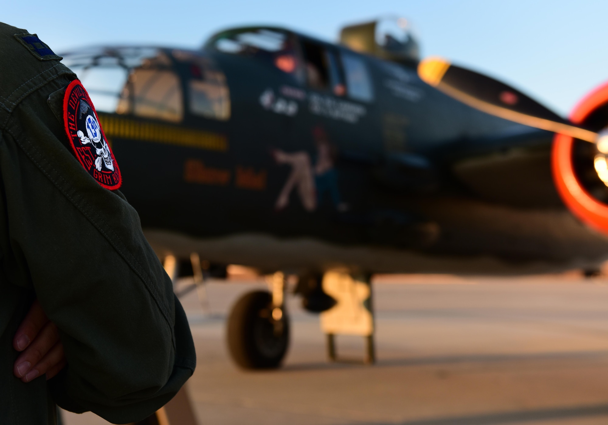 A B-2 Spirit Bomber pilot, from the 13th Bob Squadron (BS) stands in front of a North American B-25 Mitchell at Whiteman Air Force Base, Mo., June 11, 2017. The 13th BS has participated in every war since World War I and celebrated 100 years of service on June 14, 2017. (U.S. Air Force photo by Tech. Sgt. Tyler Alexander)