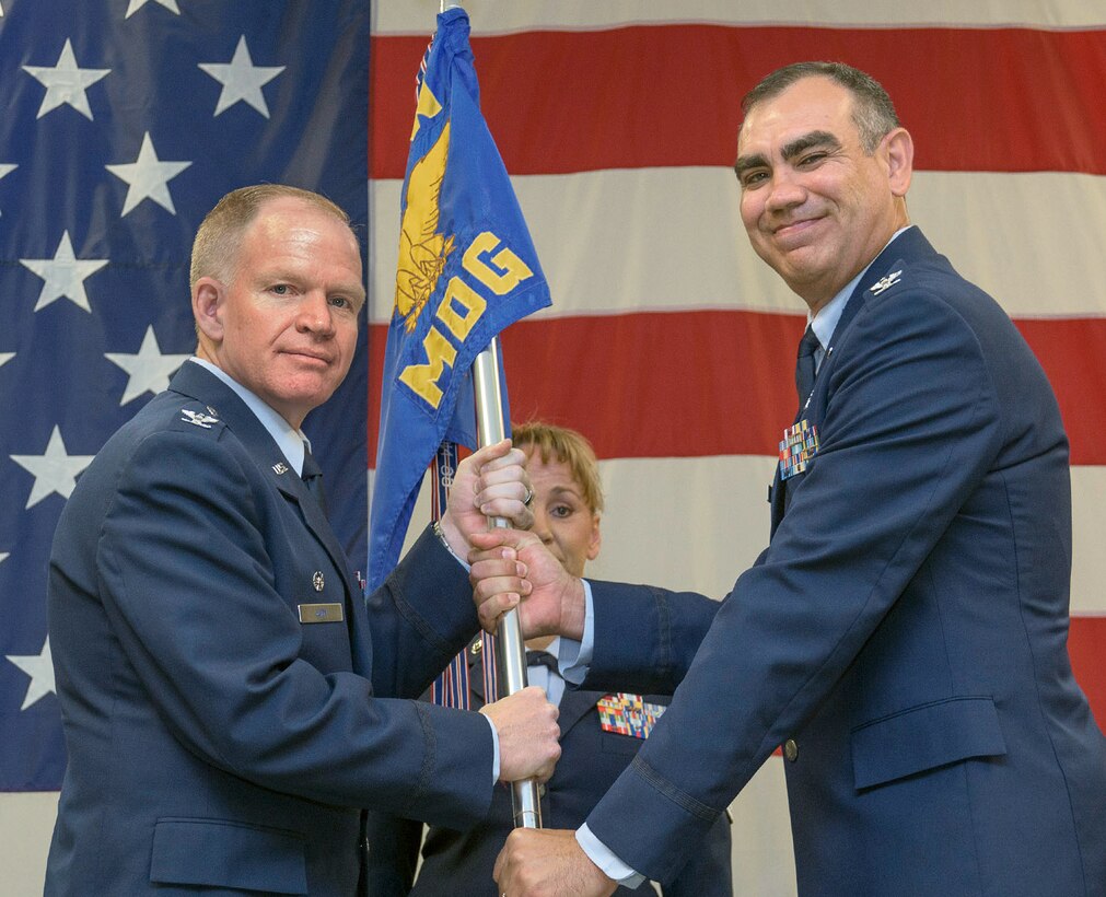 Col. (Dr.) Anthony Waldroup, right, receives the 71st Medical Group guidon from Col. Darrell Judy, 71st Flying Training Wing commander, signaling Waldroup’s acceptance of command during a change-of-command ceremony, June 15, in the Armed Forces Reserve Center at Vance Air Force Base, Oklahoma. (U.S. Air Force photo/ Terry Wasson)