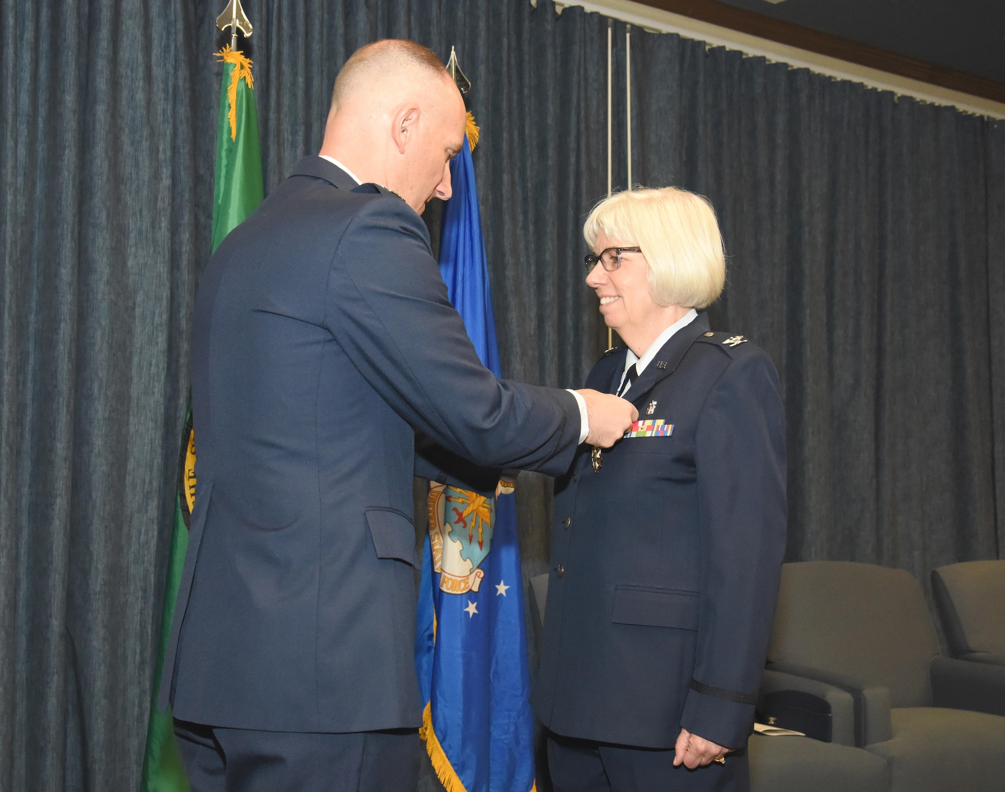 Col. Ryan Samuelson, 92nd Air Refueling Wing commander, pins the Legion of Merit Medal to the uniform of Col. Meg Carey, during the 92nd Medical Group change of command ceremony June 16, 2017 at Fairchild Air Force Base, Washington. She also was presented the Washington Air National Guard Meritorious Service Medal from Col. Dixon, 141st Maintenance Group commander.  (U.S. Air Force photo/Staff Sgt. Samantha Krolikowski)