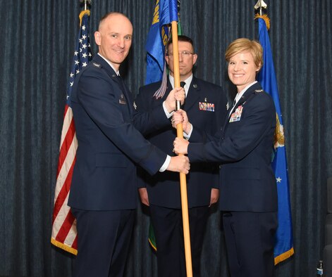 Col. Ryan Samuelson, 92nd Air Refueling Wing commander, passes the 92nd Medical Group guidon to Col. Michaelle Guerrero, 92nd MDG commander, during a change of command ceremony June 16, 2017, at Fairchild Air Force Base, Washington. Guerrero assumed command from Col. Meg Carey. (U.S. Air Force photo/Staff Sgt. Samantha Krolikowski) 