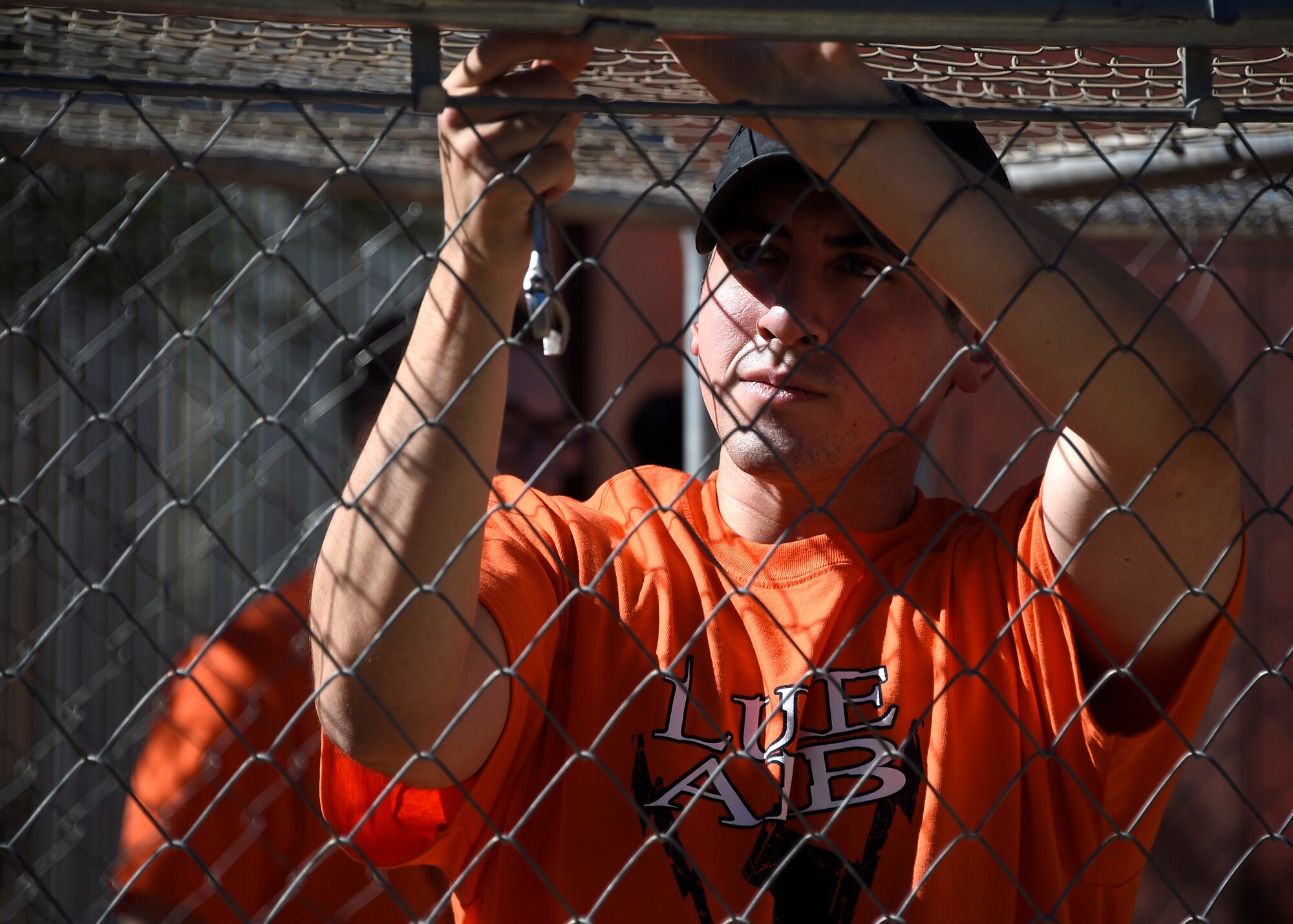 Airman assigned to the 56th Medical Group repairs a bird cage at the Fallen Feathers Wildlife Rescue operation center June 16, 2017 at Peoria, Ariz. The Luke Service Blitz featured more than 3,000 Airmen that volunteered at over 100 locations Valley-wide. Airmen spent the day giving back to organizations such as homeless shelters, community parks and trails, as well as foodbanks and animal shelters. (U.S. Air Force photo by Senior Airman Devante Williams)