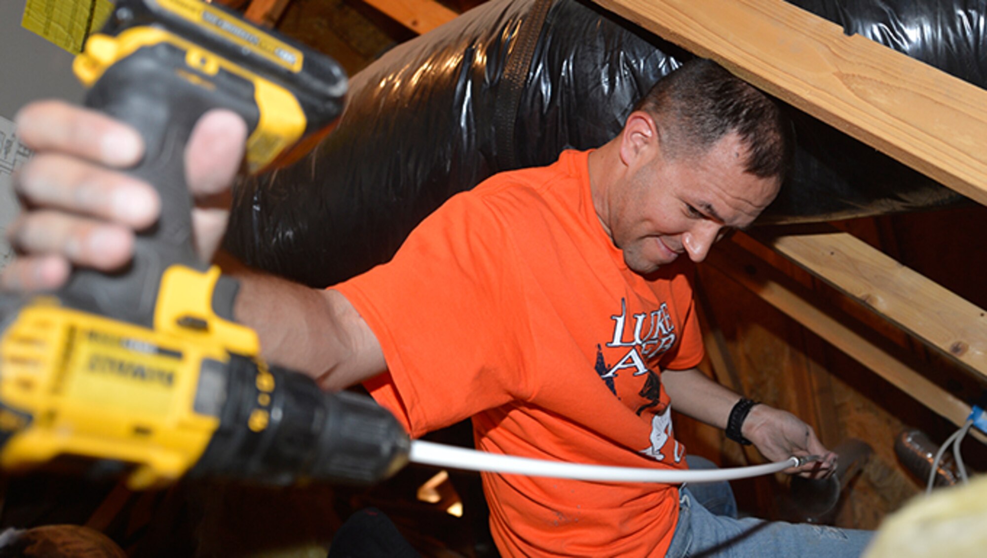 Staff Sgt. Eric Flahaut, 56th Communication Squadron cyber transport system craftsman, clears a dryer vent at Streetlight USA site June 16, 2017, in Peoria, Ariz. Flahaut with 70 other Airmen from the 56th Equipment Maintenance Squadron and 56th CS volunteered in the surrounding community during the Luke Service Blitz. (U.S. Air Force photo by Staff Sgt. Marcy Copeland)