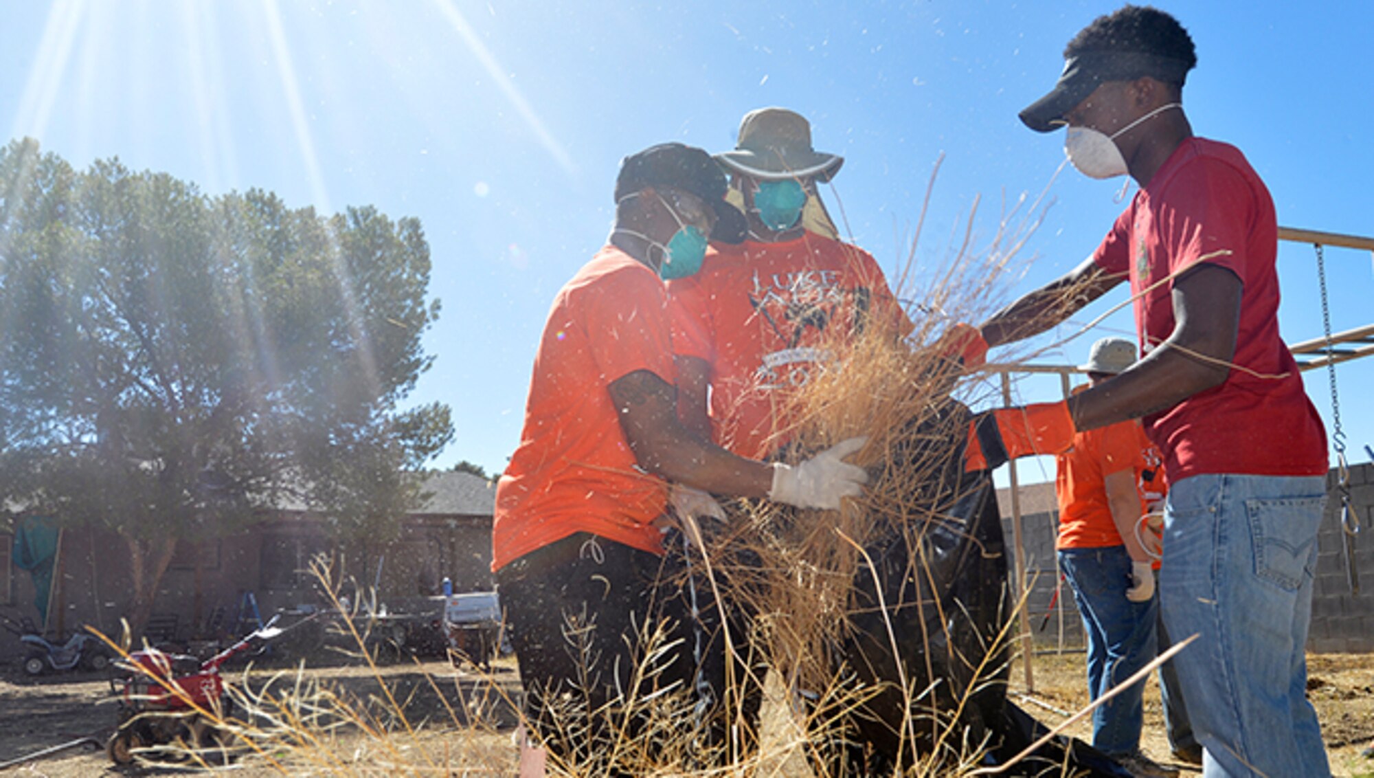 Airmen from the 56th Medical Support Squadron bag brush and debris at a Habitat for Humanity site June 16, 2017, in Peoria, Ariz. More than 3,000 Airmen volunteered in the surrounding community at more than 100 locations during the Luke Service Blitz. (U.S. Air Force photo by Staff Sgt. Marcy Copeland)