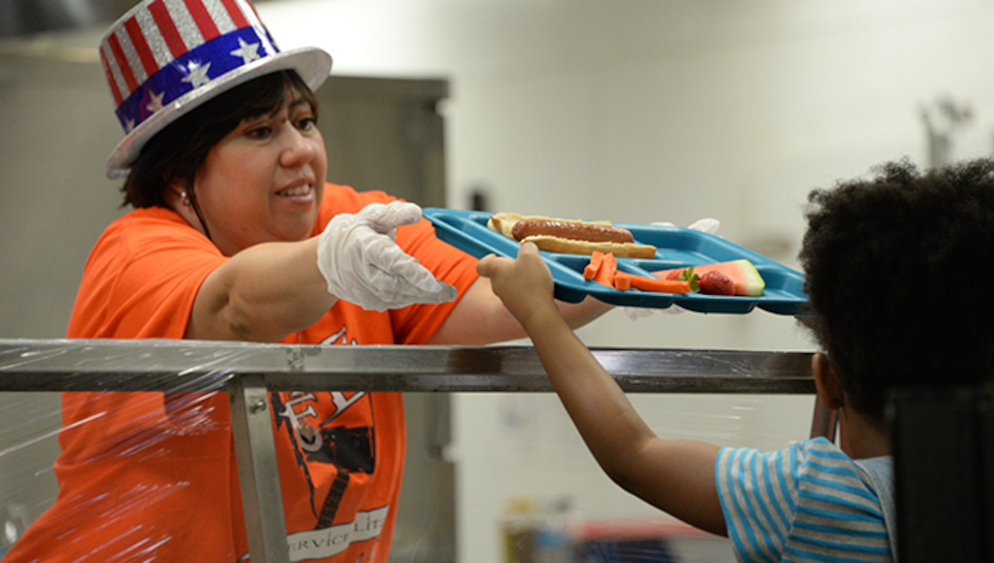 An Airman assigned to the 56th Contracting Squadron serves lunch to a child at Wigwam Creek Middle School June 16, 2017 in Litchfield Park, Ariz. Airmen from Luke Air Force Base volunteered their time as part of a Service Blitz helping surrounding community organizations which support Luke. (U.S. Air Force photo by Airman 1st Class Worpel)