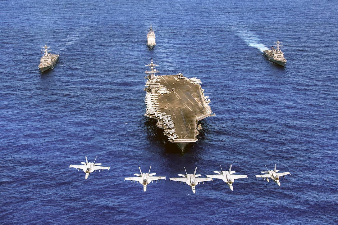 Navy F/A-18 Hornets and Super Hornets fly over the aircraft carrier USS Carl Vinson, front; the guided-missile destroyers USS Wayne E. Meyer, right, and USS Michael Murphy, left; and the guided-missile cruiser USS Lake Champlain in the western Pacific Ocean, June 12, 2017. Navy photo by Petty Officer 2nd Class Sean M. Castellano