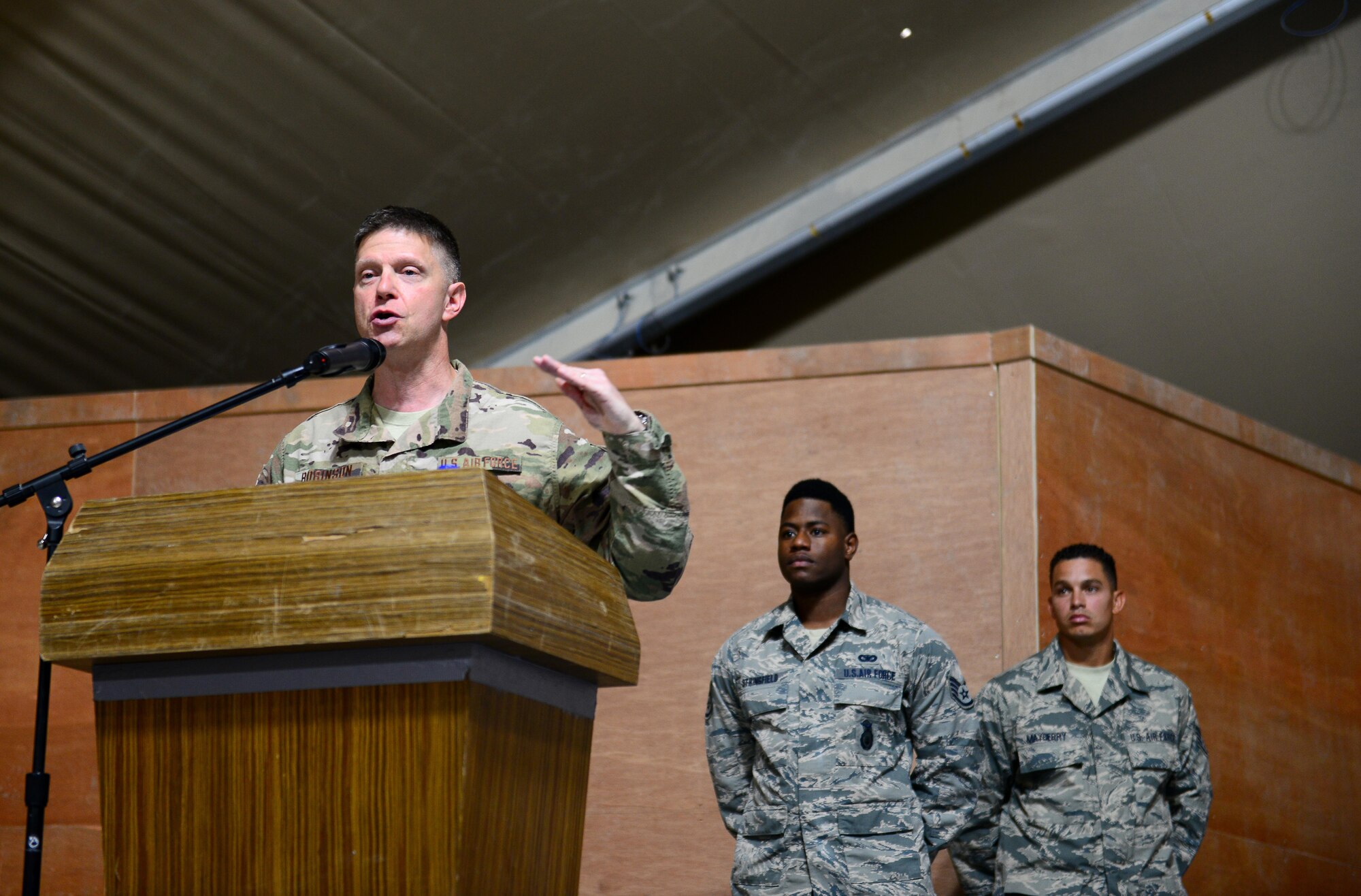 U.S. Air Force Brig. Gen. Kyle W. Robinson, 332nd Air Expeditionary Wing commander, addresses the 407th Air Expeditionary Group, coalition partners, and U.S. Marines during the 407th AEG change of command ceremony on June 17, 2017 in Southwest Asia. This ceremony signified the transfer of command between the outgoing commander Col. David C. Lyons and the incoming commander Col. John F. Gonzales to the 407th AEG. (U.S. Air Force Tech Sgt. Andy M. Kin)