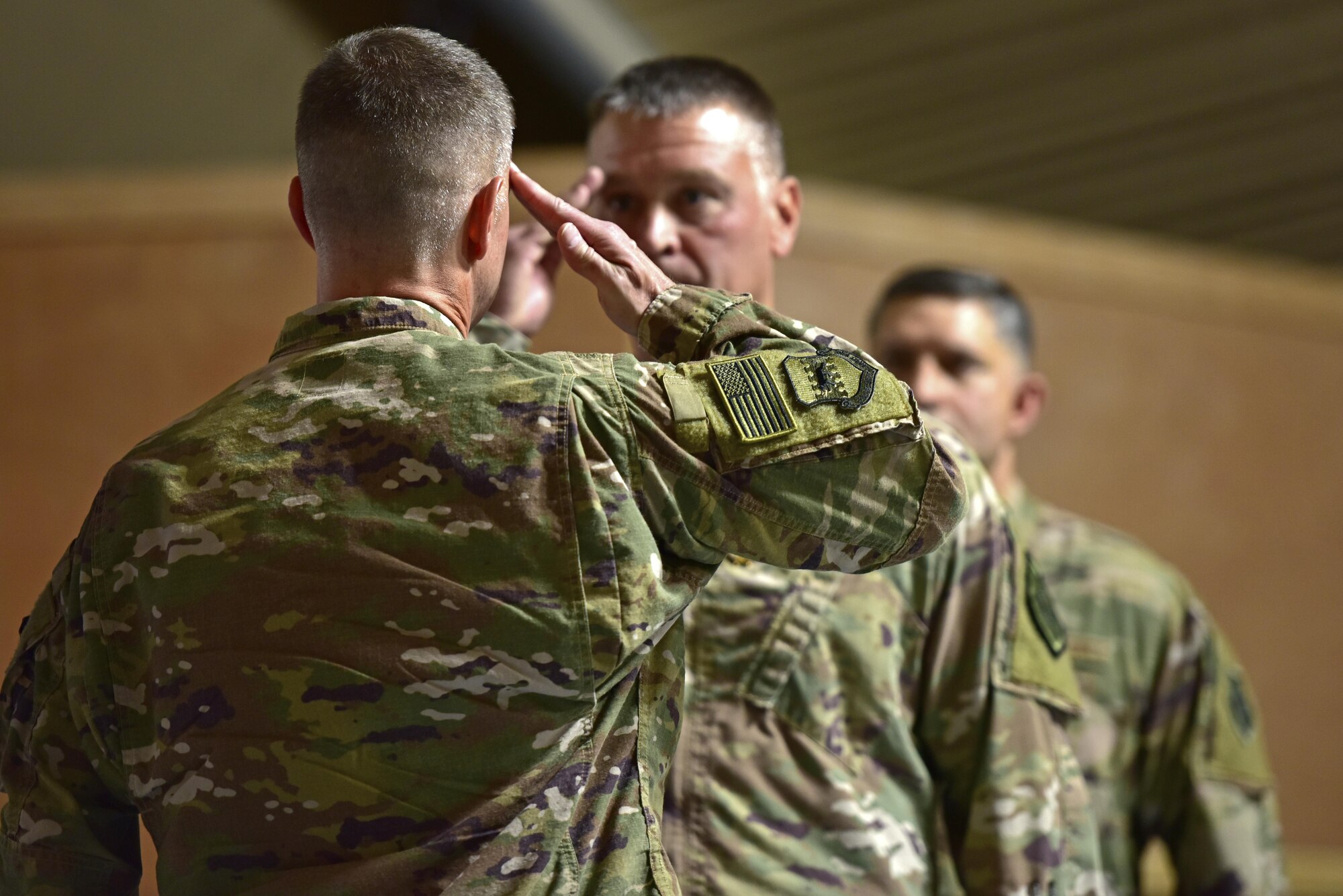 Brig. Gen Kyle Robinson, 332d Air Expeditionary Wing commander, salutes Col. David Lyons as he relinquishes Lyons from command of the 407th Air Expeditionary Group June 17, 2017, in Southwest Asia. Robinson precided over the change of command ceremony for Col. John Gonales to assume command of the 407th AEG. (U.S. Air Force photo by Senior Airman Ramon A. Adelan)