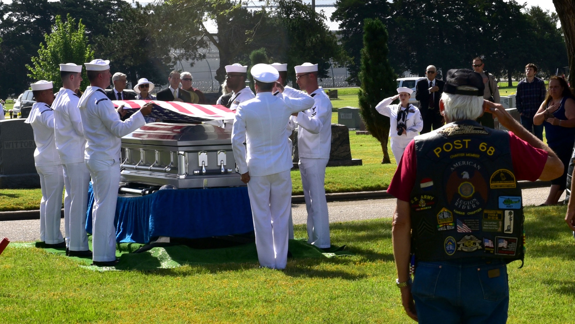 Service members, family members and other guests pay respects while Taps plays during the funeral of John Dean Armstrong, a member of the Flying Tigers, June 17, 2017, in Hutchinson, Kan. Armstrong returned home 75 years after his death in a training accident in Burma. (U.S. Air Force photo/Staff Sgt. Trevor Rhynes)