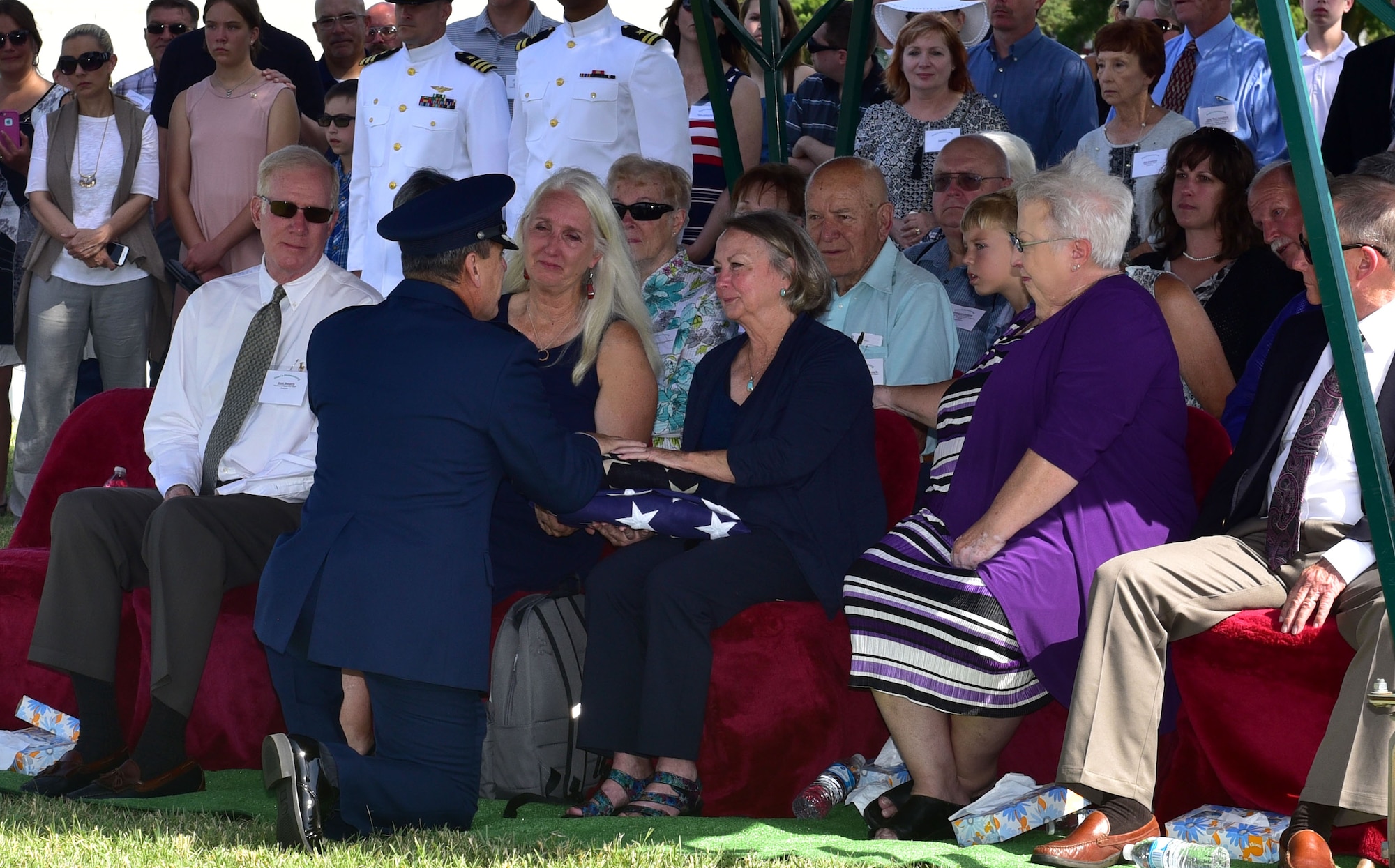 Lynn Evans, niece of John Dean Armstrong, a Flying Tiger, is presented a flag during Armstrong’s funeral, June 17, 2017, in Hutchinson, Kan. Evans was presented with a current American flag and a flag from Armstrong’s time in the American Volunteer Group. (U.S. Air Force photo/Staff Sgt. Trevor Rhynes)