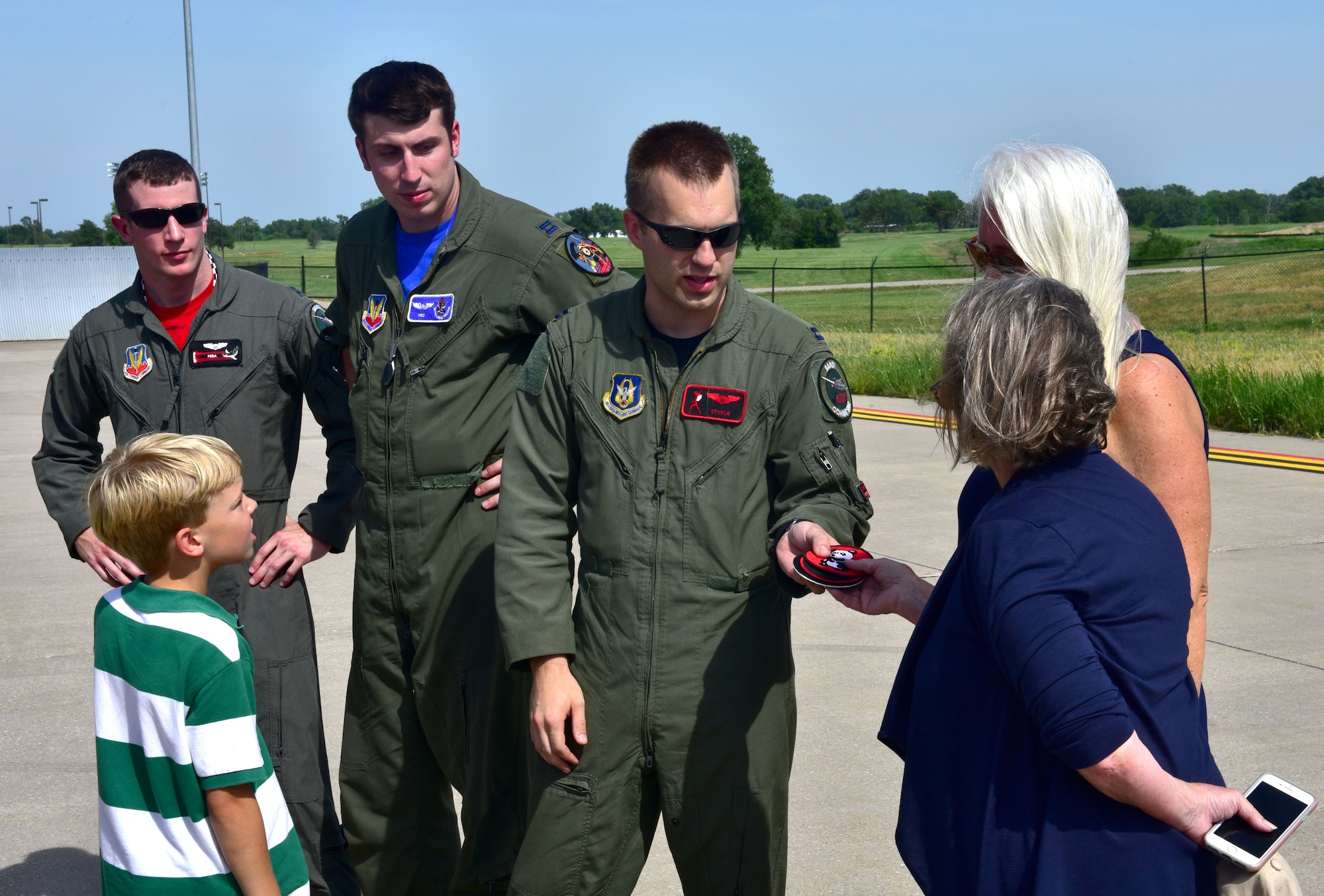 Capt. Christopher Shelly, 76th Fighter Squadron pilot, gives Lynn Evans, John Dean Armstrong’s niece, replica patches from the Flying Tigers unit that her uncle was part of, June 17, 2017, at McConnell Air Force Base, Kan. Evans and members of her family laid Armstrong to rest after searching for their missing family member’s remains for 13 years. (U.S. Air Force photo/Staff Sgt. Trevor Rhynes)