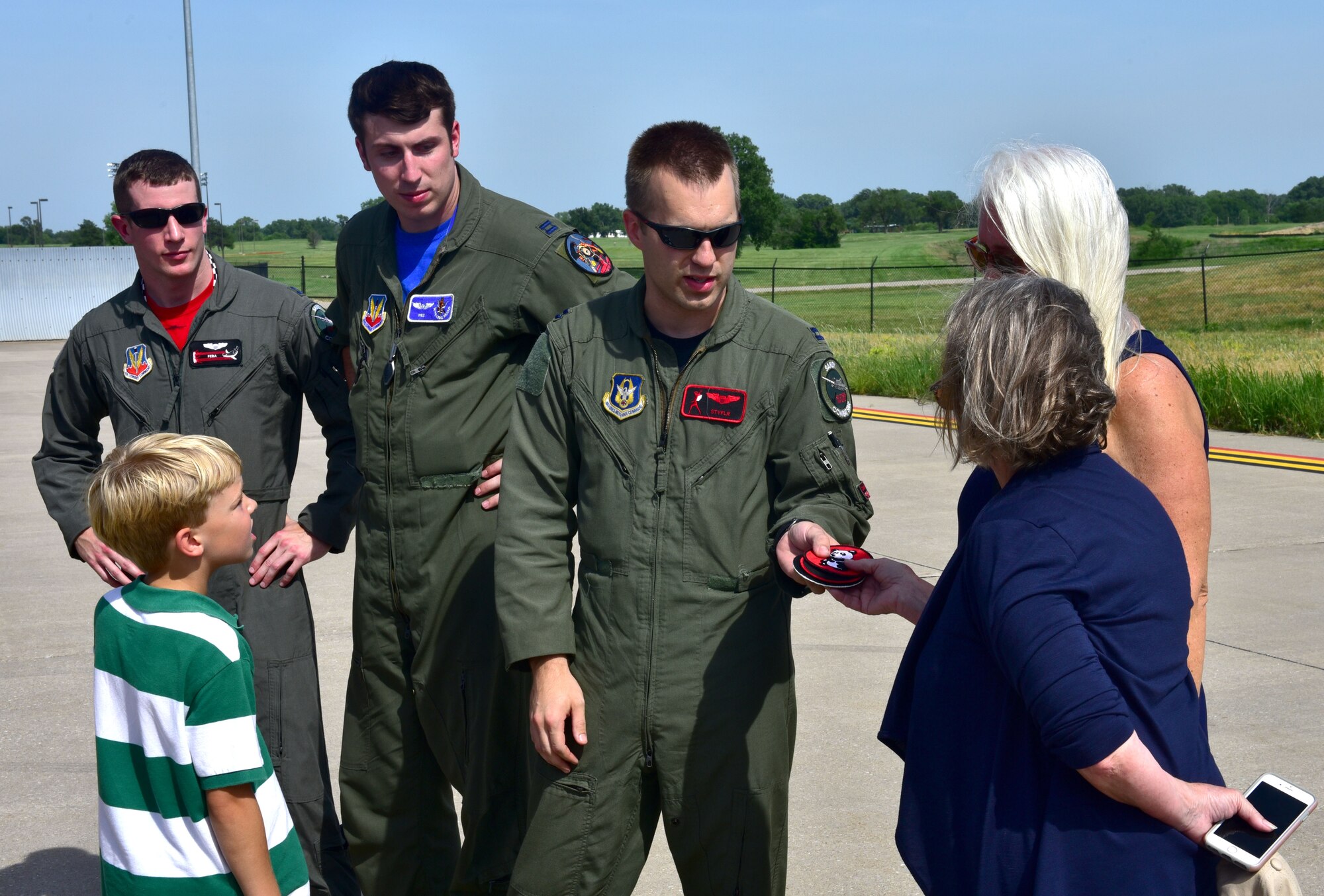 Capt. Christopher Shelly, 76th Fighter Squadron pilot, gives Lynn Evans, John Dean Armstrong’s niece, replica patches from the Flying Tigers unit that her uncle was part of, June 17, 2017, at McConnell Air Force Base, Kan. Evans and members of her family laid Armstrong to rest after searching for their missing family member’s remains for 13 years. (U.S. Air Force photo/Staff Sgt. Trevor Rhynes)