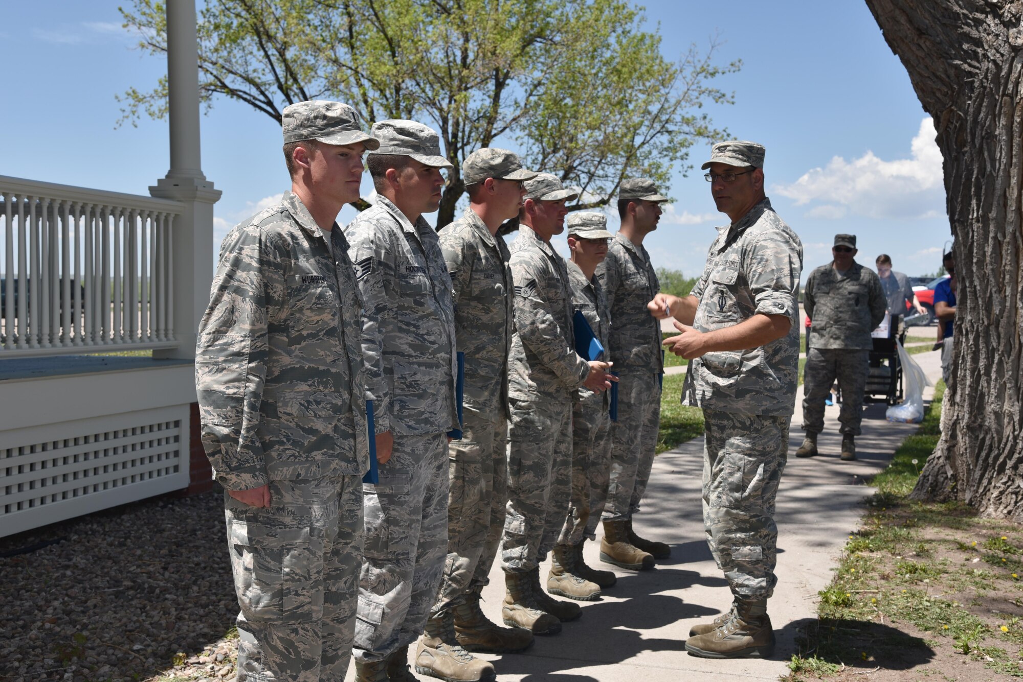 90th Civil Engineer Airmen are awarded the Air Force Achievement medal and receive coins from Col. Stephen Kravitsky, 90th Missile Wing commander for the restoration of the historic Fort D. A. Russell Army post headquarters at F.E. Warren Air Force Base, Wyo., June 8, 2017. The renovation project served a dual purpose by providing a rare training opportunity to prepare civil engineer Airmen for their responsibilities when deployed to foreign countries. Building 210 will act as the MSG headquarters and a receptions hall for Distinguished Visitors. (U.S. Air Force photo by 2nd Lt. Nikita Thorpe)