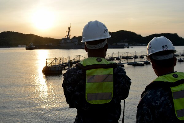 Sailors watch pier-side as the Arleigh Burke-class guided-missile destroyer USS Fitzgerald returns to Fleet Activities Yokosuka, June 17, 2017, following a collision with a merchant vessel while operating southwest of Yokosuka, Japan. Navy photo by Petty Officer 1st Class Peter Burghart