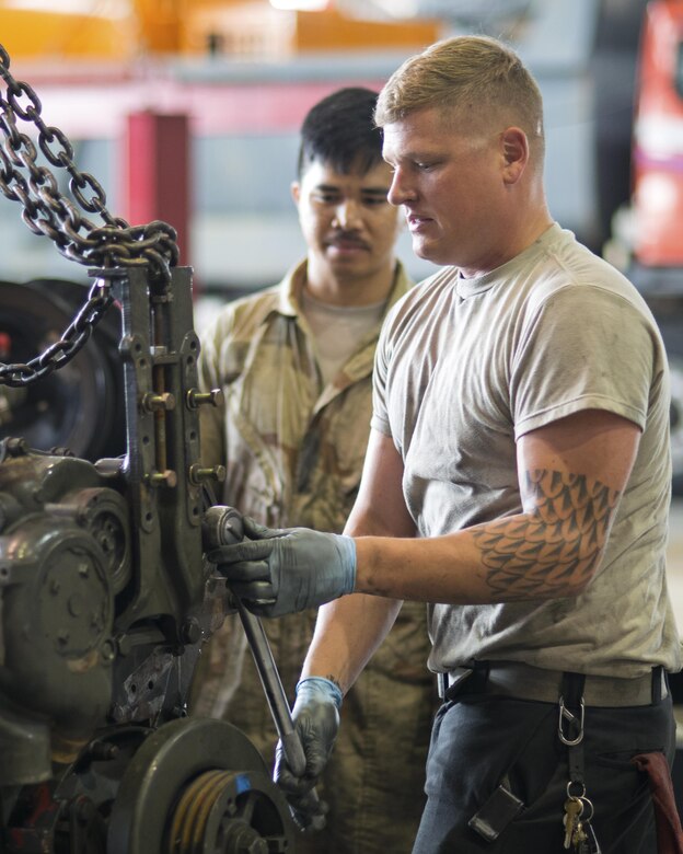 U.S. Air Force Senior Airman Jeremy Butler, 51st Logistics Readiness Squadron vehicle maintainer, disassembles an engine in the Vehicle Maintenance shop at Osan Air Base, Republic of Korea on June 13, 2017. The 51st LRS handles all maintenance on government owned vehicles on base. (U.S. Air Force photo by Staff Sgt. Alex Fox Echols III)