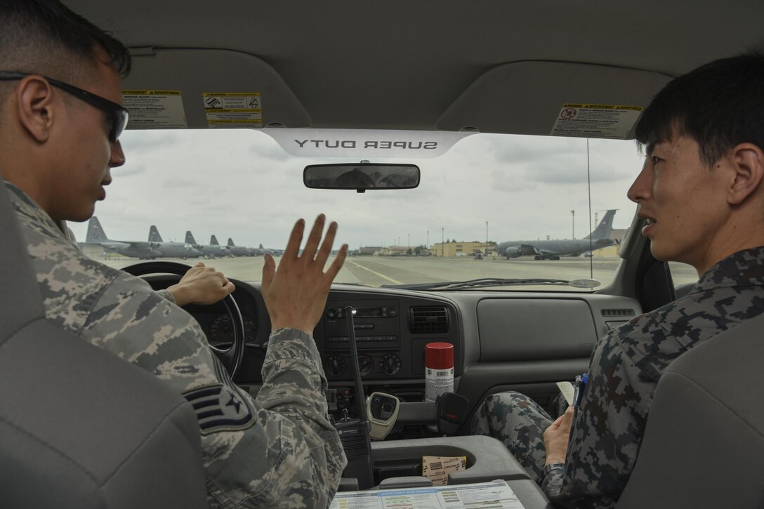 U.S. Air Force Staff Sgt. Michael Ober, 374th Operation Support Squadron non-commisiioned officer in charge of airfield management training, briefs while conducting a runway inspection during the Bilateral Exchange Program at Yokota Air Base, Japan, June 7, 2017. The program allowed American and Japanese Forces the opportunity to work together and learn from each other's daily operations and build a stronger relationship. (U.S. Air Force photo by Machiko Arita)