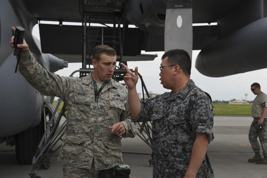 Japan Air Self-Defense Force Staff Sgt. Tatsuya Suzuki, 1st Techinical School Maintenance Section aircraft engine maintenance, asks a question about C-130 Hercules engine troubleshooting procesures to U.S. Air Force Tech. Sgt. Daylon Siverly, 374th Maintenance Squadron dock coordinator, during the Bilateral Exchange Program at Yokota Air Base, Japan, June 7, 2017. The program allowed American and Japanese Forces the opportunity to work together and learn from each other's daily operations and build a stronger relationship. (U.S. Air Force photo by Machiko Arita)