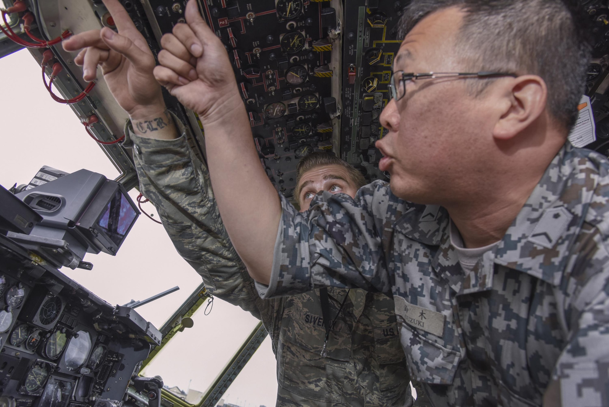 U.S. Air Force Tech. Sgt. Daylon Siverly, 374th Maintenance Squadron dock coordinator, briefs on how to start a C-130 Hercules engine during the Bilateral Exchange Program at Yokota Air Base, Japan, June 7, 2017. A total of 14 Japan Air Self-Defense Force members from a variety of career fields participated in the program. They were provided with hands-on experience working in their related fields to see how Yokota conducts its mission. (U.S. Air Force photo by Machiko Arita)
