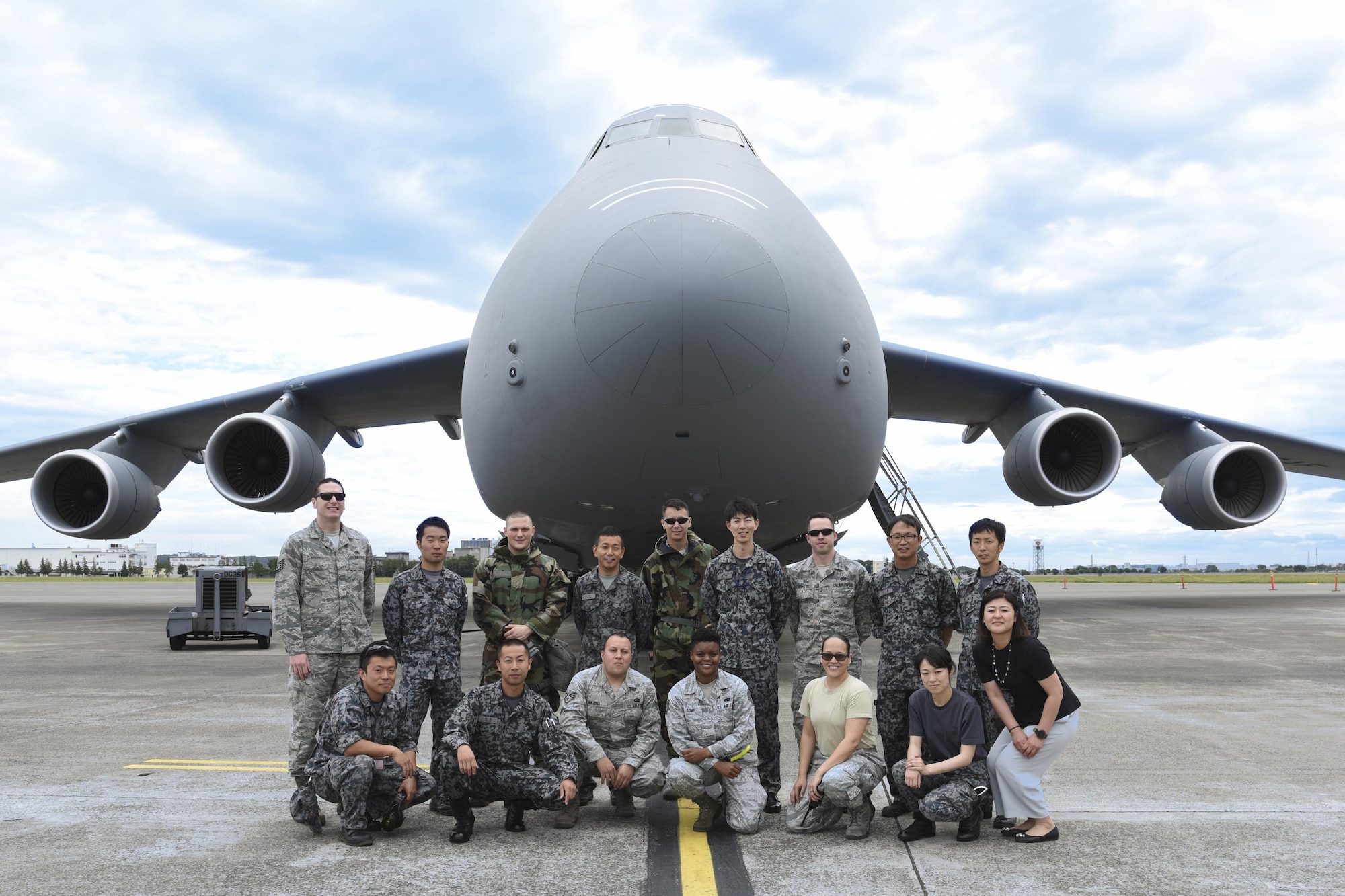 Participants in the Bilateral Exchange Program pose in front of a C-5M Super Galaxy at Yokota Air Base, Japan, June 8, 2017. The 730th Air Mobility Squadron conducts a tour of the C-5M Super Galaxy to Japan Air Self-Defense Force members as part of the program. (U.S. Air Force photo by Machiko Arita)