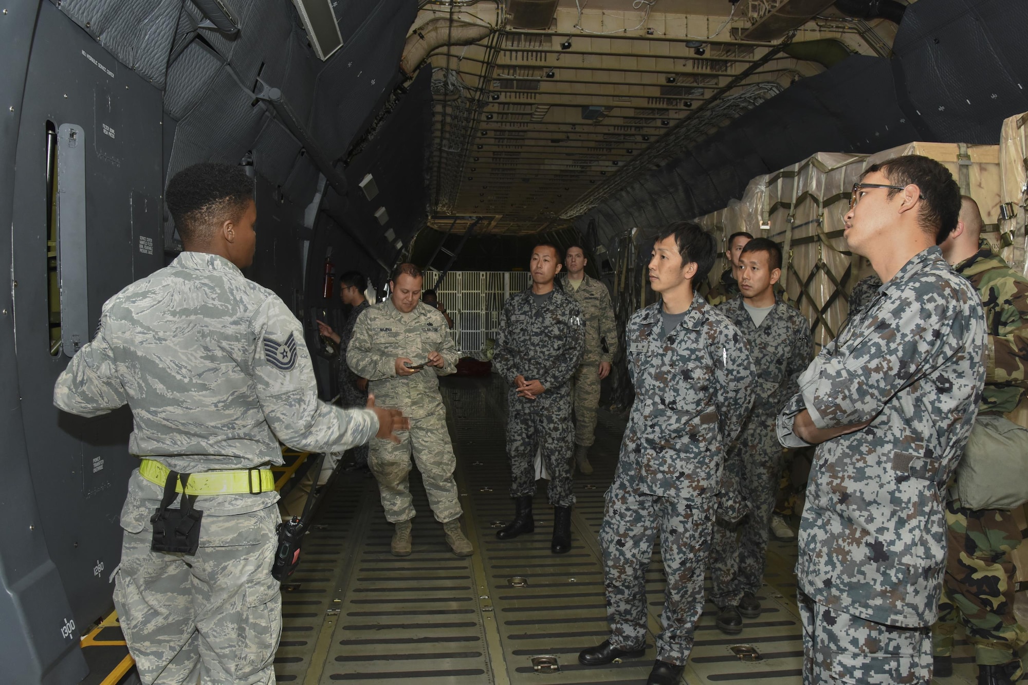 U.S. Air Force Tech. Sgt. Brittany Kemp, 730th Air Mobility Squadron crew chief, briefs participants on a C-5M Super Galaxy during the Bilateral Exchange Program at Yokota Air Base, Japan, June 8, 2017. The 730th Air Mobility Squadron conducts a tour of the C-5M Super Galaxy to Japan Air Self-Defense Force members as part of the program. (U.S. Air Force photo by Machiko Arita)