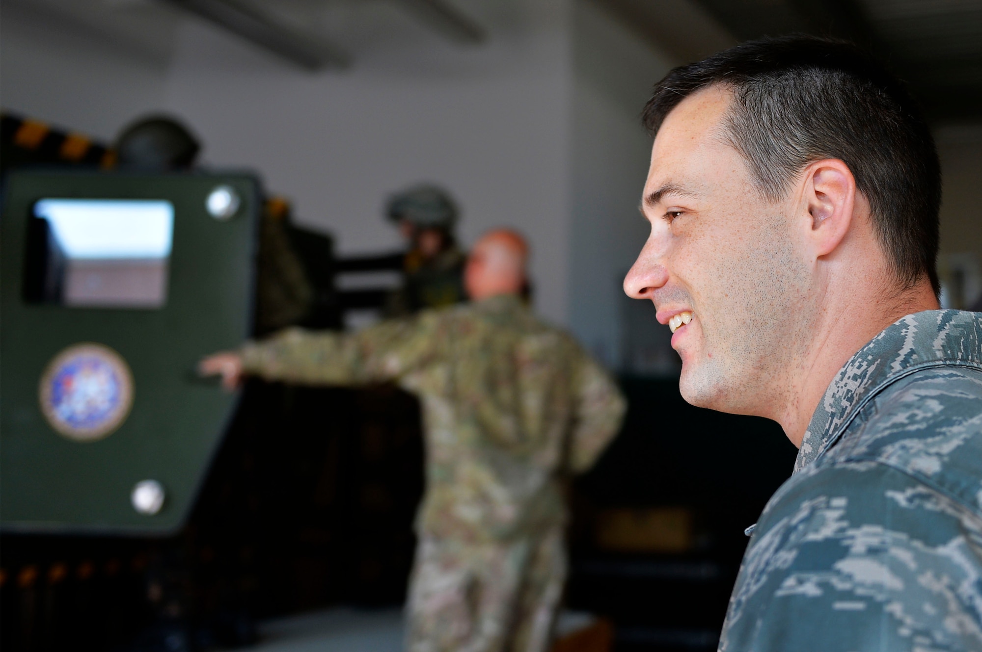 U.S. Air Force Staff Sgt. Dallas Rhodes, 7th Weather Squadron unit deployment manager, watches as troops enter a Humvee egress assistance trainer on Lucius D. Clay Kaserne, Germany, June 14, 2017. The 7th WS conducted Exercise Cadre Focus 17-1, which aims to help its Airmen enhance their ability to integrate with the U.S. Army. German, Polish, and Hungarian service members also participated in the exercise. (U.S. Air Force photo by Airman 1st Class Joshua Magbanua)