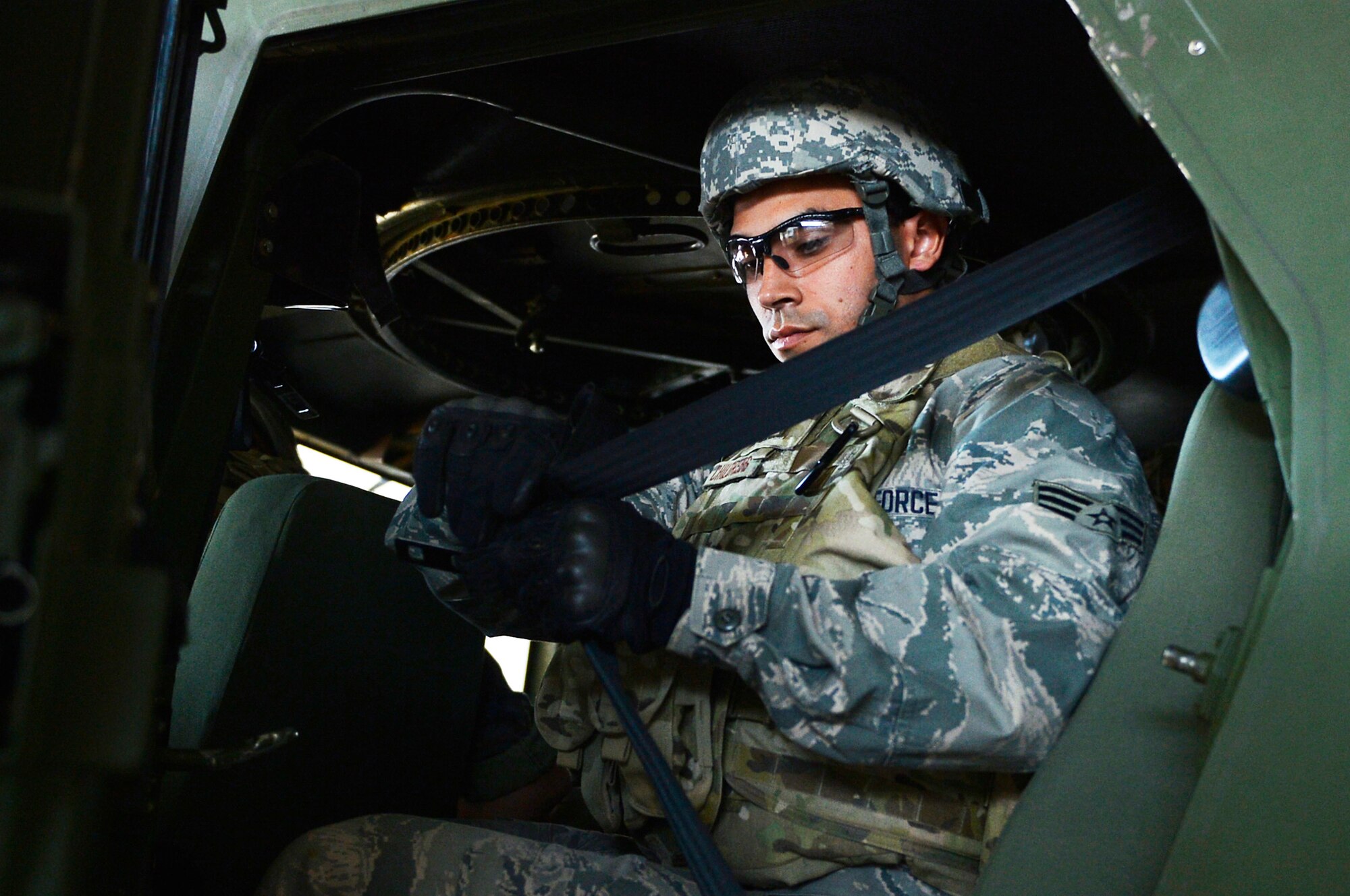 U.S. Air Force Senior Airman Jose Peregrina-Flores, 7th Weather Squadron regional maintenance technician, straps himself to a Humvee egress assistance trainer on Lucius D. Clay Kaserne, Germany, June 14, 2017. The 7th WS conducts HEAT training annually in order to ensure its Airmen are capable of evacuate a rolled-over Humvee. The squadron is responsible for providing weather support to U.S. Army operations in Europe. (U.S. Air Force photo by Airman 1st Class Joshua Magbanua)