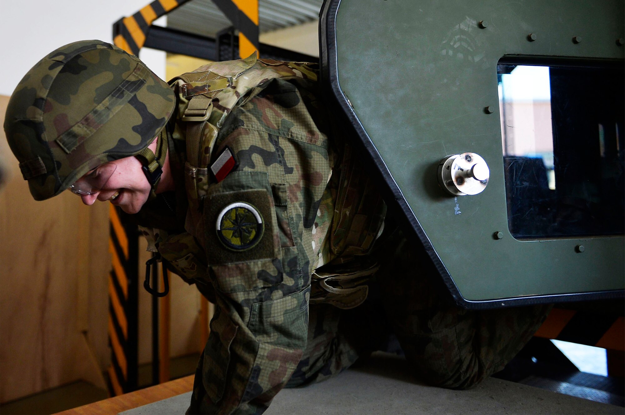 Capt. Ewa Betke, training branch officer for the Hydrometeorological Service of the Polish Armed Forces, exits a Humvee egress assistance trainer on Lucius D. Clay Kaserne, Germany, June 14, 2017. German, Hungarian, and Polish, troops participated with U.S. Airmen in Exercise Cadre Focus 17-1. The 7th Weather Squadron conducts the exercise to enhance its Airmen’s ability to cooperative with the U.S. Army (U.S. Air Force photo by Airman 1st Class Joshua Magbanua).