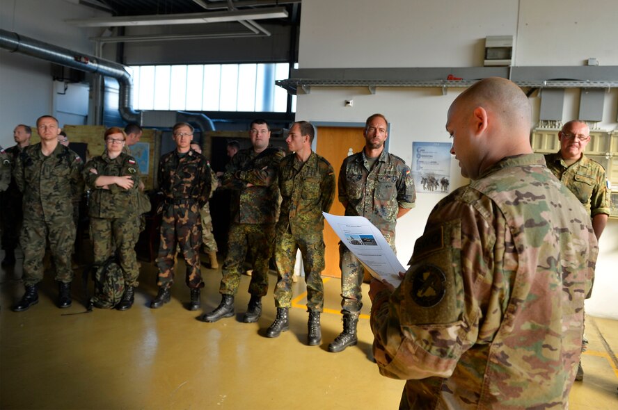 U.S. Air Force Master Sgt. Steven Hollatz, 7th Weather Squadron non-commissioned officer in charge of education and training, left, and Master Sgt. Richard Koch, 7th WS NCO in charge of readiness, operate a Humvee egress assistance trainer on Lucius D. Clay Kaserne, Germany, June 14, 2017. A HEAT machine is designed to simulate a Humvee rolling over. The 7th WS trains its Airmen in various common Soldier tasks in order to ensure their capability to cooperate with the U.S. Army. (U.S. Air Force photo by Airman 1st Class Joshua Magbanua)