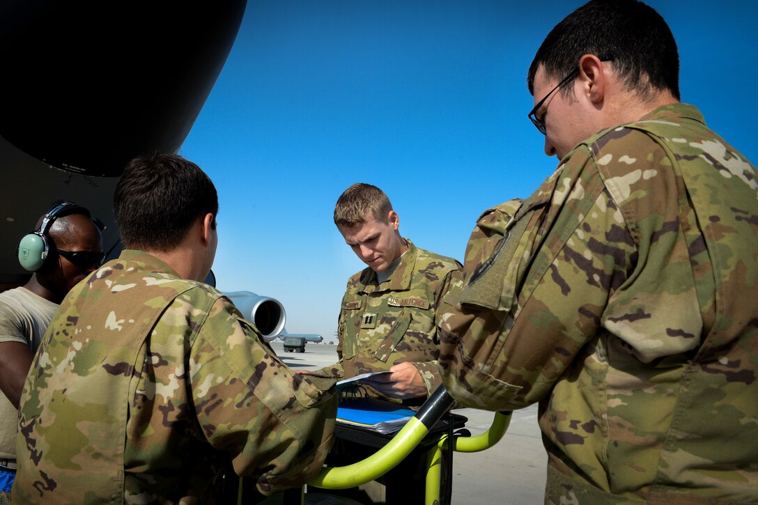 Air Force Capt. Christopher Chorney reviews KC-135 Stratotanker maintenance records with airmen before a flight in support of Operation Inherent Resolve at Al Udeid Air Base, Qatar, June 9, 2017. Chorney is a pilot assigned to the 340th Expeditionary Air Refueling Squadron. The airmen are maintainers assigned to the 340th Aircraft Maintenance Unit. Air Force photo by Staff Sgt. Michael Battles
