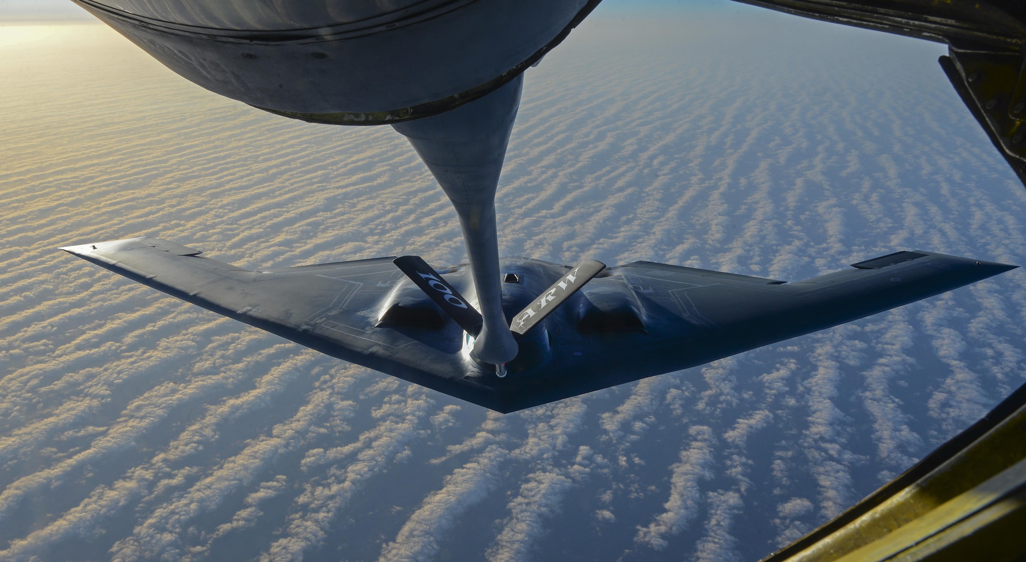 A U.S. Air Force KC-135 Stratotanker assigned to the 100th Air Refueling Wing, RAF Mildenhall, England, prepares to transfer fuel to a B-2 Spirit from Whiteman Air Force Base, Mo., off the coast of Spain, June 13, 2017. Two B-2s deployed to the U.K. to participate in theater bomber assurance and deterrence operations. Bomber deployments enhance the readiness and training necessary to respond to any contingency or challenge across the globe. (U.S. Air Force photo by Staff Sgt. Micaiah Anthony)