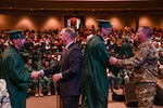 Louisiana National Guard's Maj. Gen. Glenn H. Curtis, the adjutant general of the LANG, and Gov. John Bel Edwards shake hands with Youth Challenge Program cadets during a graduation ceremony in Alexandria, Louisiana, June 10, 2017. The LANG's YCP graduates approximately 1,400 cadets a year from three locations: Camp Beauregard in Pineville, Camp Minden near Shreveport and Gillis W. Long Center in Carville. 