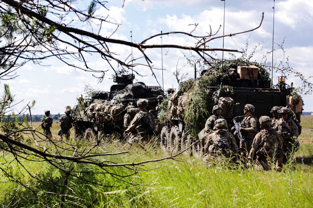 Soldiers camouflage tactical vehicles during exercise Saber Strike 17 at the Bemowo Piskie Training Area, Poland, June 14, 2017. Army photo by Spc. Samuel Brooks