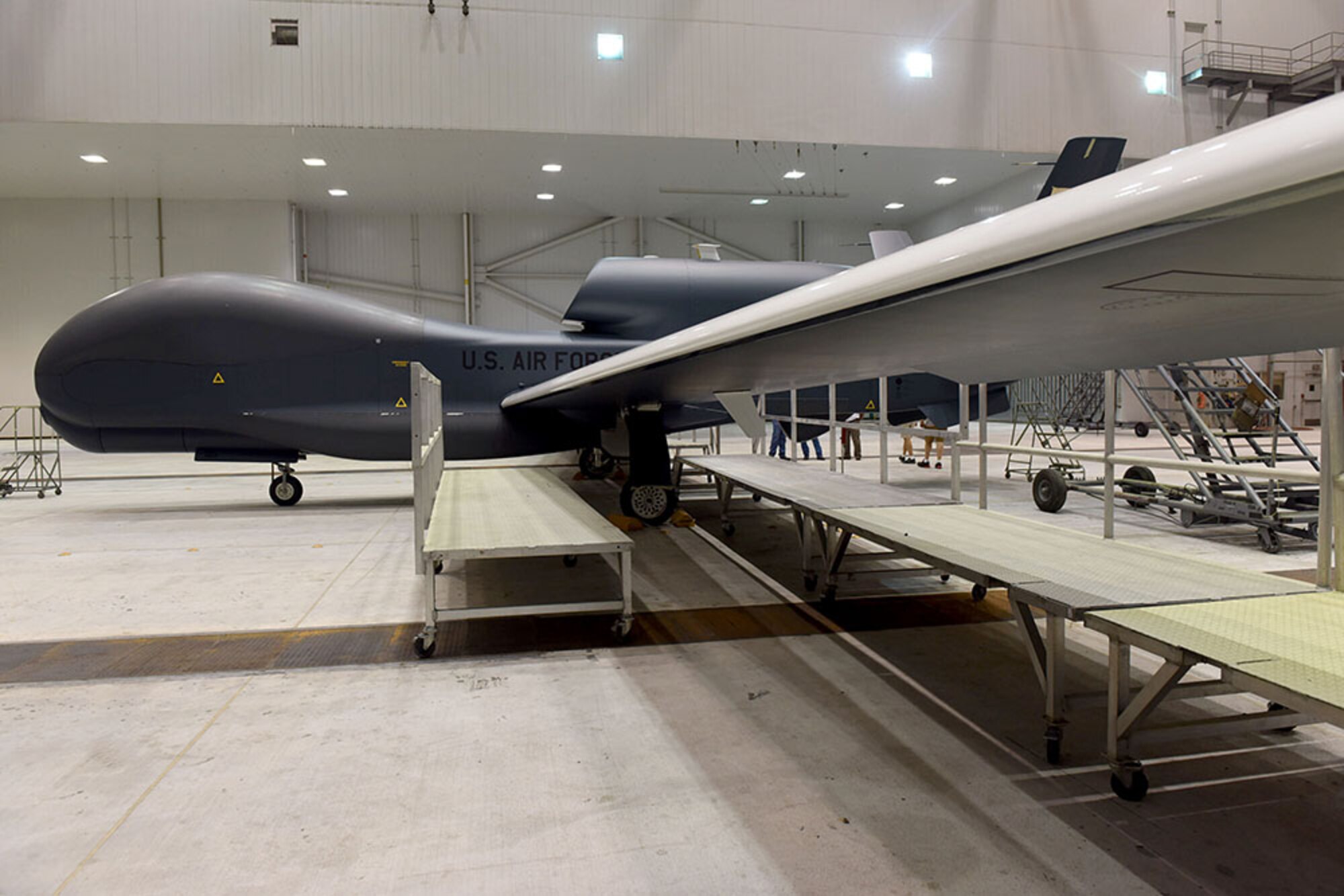 Lt. Gen. Lee Levy II, Air Force Sustainment Center commander, met with  members of Team Robins about work being done on a Global Hawk here during his site visit June 13. This is the first time a Global Hawk has flown into  an Air Force air logistics complex. Warner Robins Air Logistics Complex maintenance professionals are meticulously painting the aircraft to prevent corrosion. Robins Air Force Base is the first installation to have a building-based Launch and Recovery Element, allowing the aircraft to take off and land from this location. While a programmed depot maintenance requirement for Global Hawk has not been established, the Air Force recognizes that having an organic maintenance capability for Global Hawk enhances our ability to manage the fleet and keep this resource flying. (U.S. Air Force photo/TOMMIE HORTON) 
