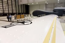 Lt. Gen. Lee Levy II, Air Force Sustainment Center commander, met with  members of Team Robins about work being done on a Global Hawk here during his site visit June 13. This is the first time a Global Hawk has flown into  an Air Force air logistics complex. Warner Robins Air Logistics Complex maintenance professionals are meticulously painting the aircraft to prevent corrosion. Robins Air Force Base is the first installation to have a building-based Launch and Recovery Element, allowing the aircraft to take off and land from this location. While a programmed depot maintenance requirement for Global Hawk has not been established, the Air Force recognizes that having an organic maintenance capability for Global Hawk enhances our ability to manage the fleet and keep this resource flying. (U.S. Air Force photo/TOMMIE HORTON) 
