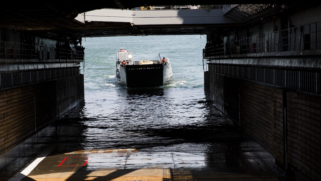 Marines and sailors work together to bring a Humvee aboard the USS Whidbey Island, June 13, 2017. Military personnel across the Department of Defense are making preparations for Sail Boston 2017, to showcase the vast capabilities of the United States amphibious forces, to the public. Some of the vehicles and weapons on display will include a Marine Corps Humvee, a U.S. Navy MH-53E Sea Dragon, and a wide array of weapons systems