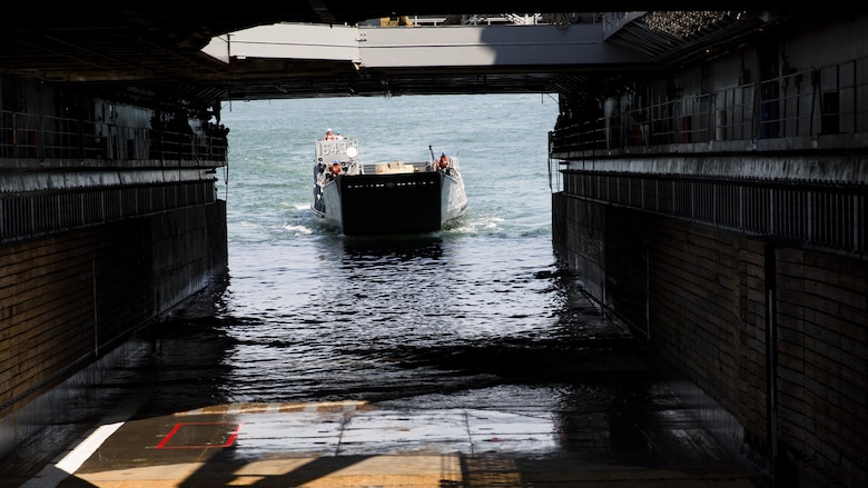 Marines and sailors work together to bring a Humvee aboard the USS Whidbey Island, June 13, 2017. Military personnel across the Department of Defense are making preparations for Sail Boston 2017, to showcase the vast capabilities of the United States amphibious forces, to the public. Some of the vehicles and weapons on display will include a Marine Corps Humvee, a U.S. Navy MH-53E Sea Dragon, and a wide array of weapons systems