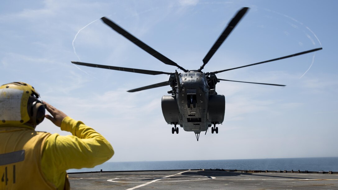 An MH-53 helicopter conducts practice flights aboard the USS Whidbey Island, June 13, 2017. Military personel all across the department of defense are making preparations for Sail Boston 2017 to showcase their vast cabailities to the public. The sailors conducted practice flights in preparation to display the capabilites of an MH-53 helicopter. The sailors are assigned to HM15. 