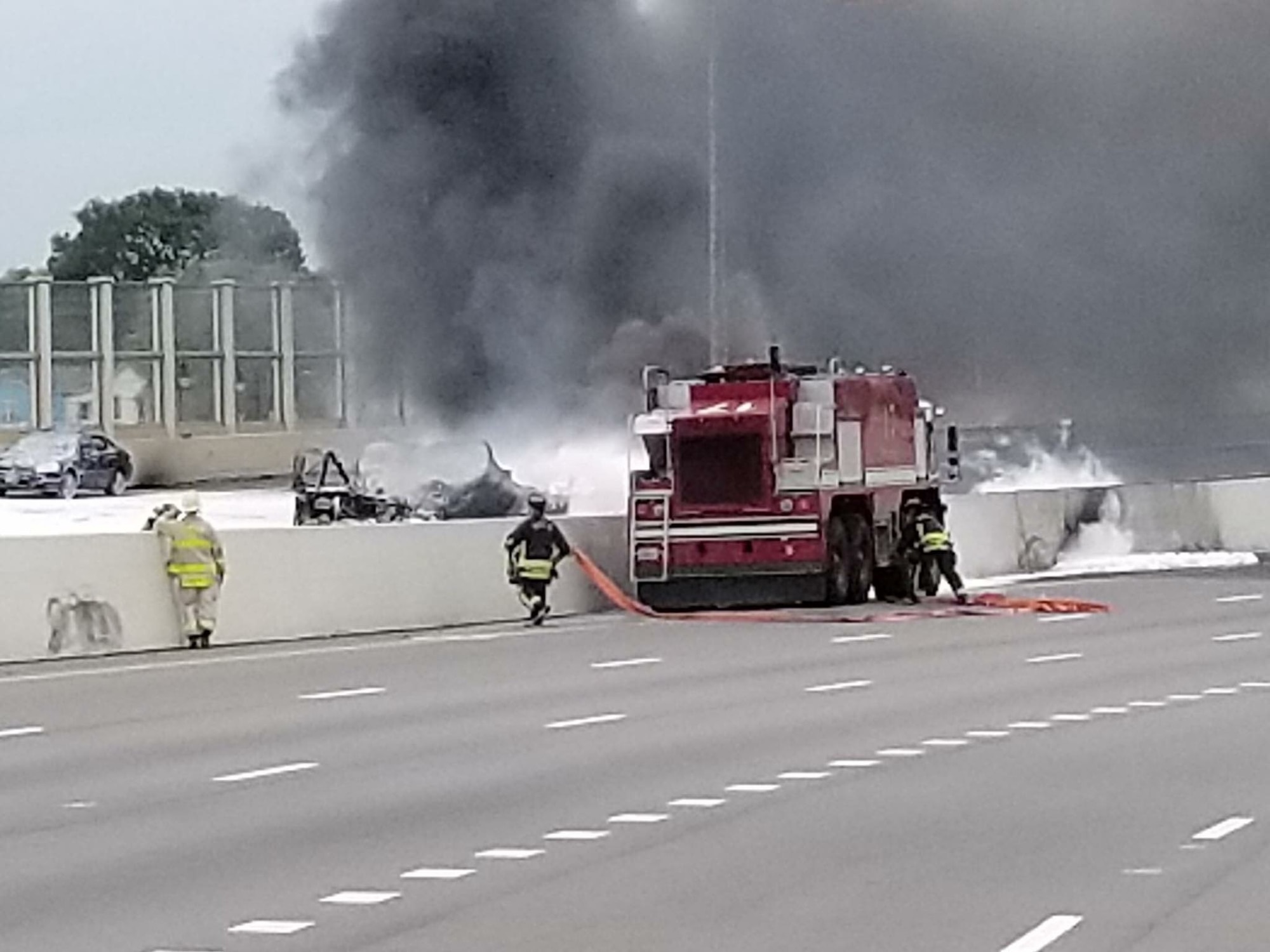 Wright-Patterson fire fighters assist Dayton first responders as they battle a major fuel fire on I-75 April 30, 2017 in Dayton, Ohio. After using foam to combat the fire from the ARFF crash vehicle, Wright-Patterson fire fighters passed hoses to Dayton fire fighters to extinguish the remaining fire. (U.S. Air Force photo/Keith Hawkins)  
