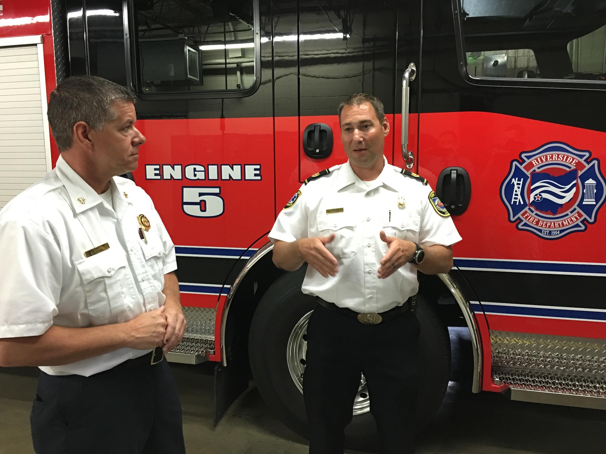 Fire Chief Jacob King, Wright-Patterson Air Force Base Fire Emergency Services (right) discusses mutual aid operations with Fire Chief Daniel Stitzel, city of Riverside Fire Department, in front of Riverside’s newest fire engine June 9, 2017 in Riverside, Ohio. Both departments routinely provide mutual aid to one another in the form of firefighting, medical, diving and other emergency response services. (U.S. Air Force photo/John Harrington)