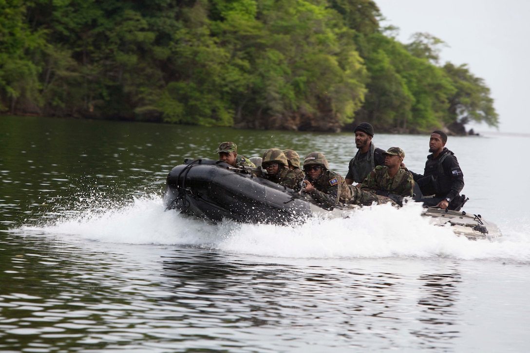 Members of 1st and 2nd Infantry Battalion, Trinindad and Tabago Infantry Regiment, Trinidad and Tobago Defence Force, and soldiers from the Belize Defense Force simulate a beach raid during Phase II of Exercise Tradewinds 2017 in Port of Spain, Trinidad and Tobago, June 13, 2017. Tradewinds, an annual U.S. Southern Command-sponsored exercise, brings together 20 partner nations to increase Caribbean security and the combined ability to counter transnational terrorism and organize crime, and enhance humanitarian and disaster relief capabilities.  (U.S. Marine Corps photo by Sgt. Clemente C. Garcia)