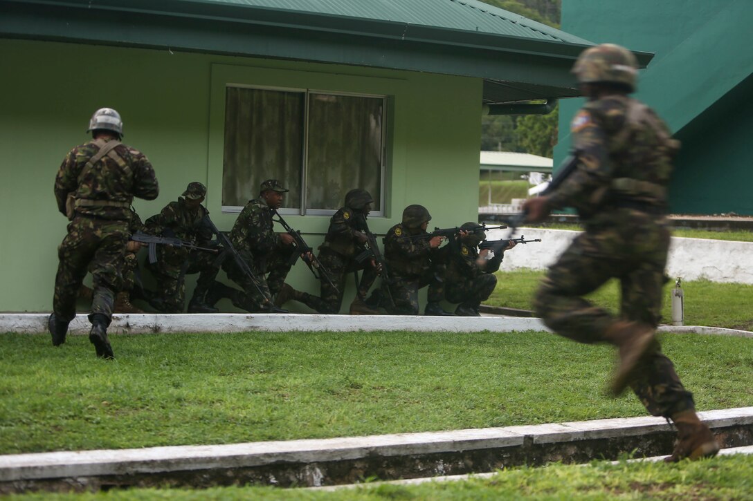 Belize Defence Force soldiers take cover while conducting a simulated aerial and maritime raid during Exercise Tradewinds 2017 Phase II in Chaguaramas, Trinidad and Tobago, June 13, 2017. Tradewinds, an annual U.S. Southern Command-sponsored exercise, brings together 20 partner nations to increase Caribbean security and the combined ability to counter transnational terrorism and organize crime, and enhance humanitarian and disaster relief capabilities. (U.S. Marine Corps photo by Sgt. Olivia McDonald)
