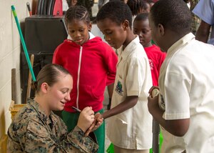 U.S. Marine Sgt. Olivia McDonald, a mass communicator with II Marine Expeditionary Force, signs a child’s hand at Carenage Boy Government Primary School as part of a community relations event during Phase II of Exercise Tradewinds 2017 in Chaguaramas, Trinidad and Tobago, June 16, 2017. This year marks the 33rd iteration of the regionally focused, multi-nationally planned exercise, which dates back to 1984. McDonald, a Medford, Massachusetts, native, and other Marines are providing training and logistical support for the exercise. (U.S. Marine Corps photo by Sgt. Clemente C. Garcia)