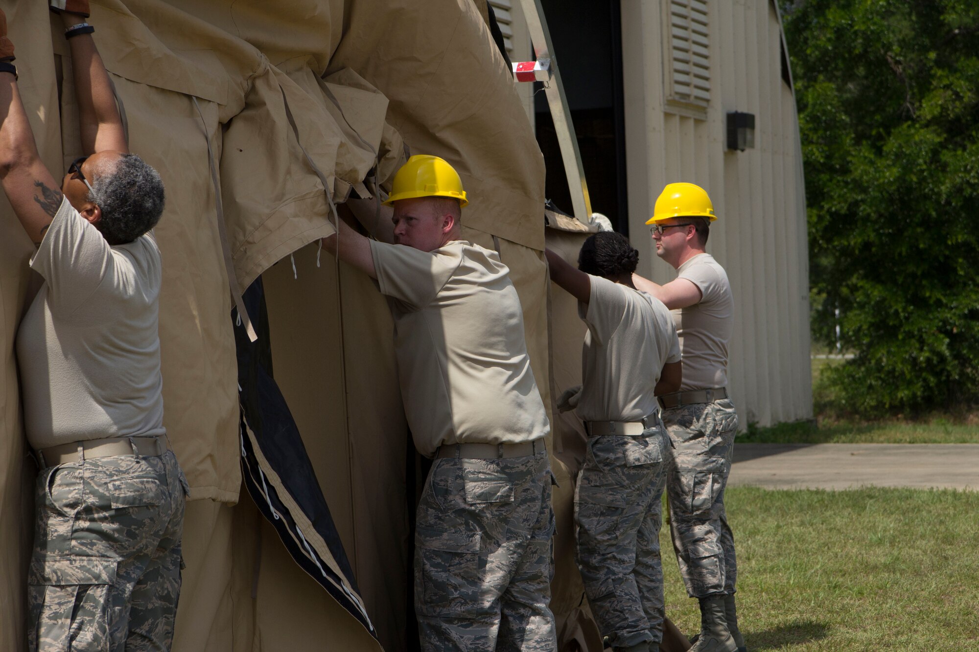 Master Sgt. Sonija Nelson, Tech. Sgt. Jason Billingsley
and Tech. Sgt. Aaron Hooper, from the 442nd Force Support Squadron's Services Flight, construct a tent with a member of the 919th Force Support Squadron, which is part of a single pallet expeditionary kitchen used for preparing food in deployed locations.  The 919 FSS hosted the 442 FSS
members during a two-week deployment for training to Duke Field, Fla., May 6-20.

