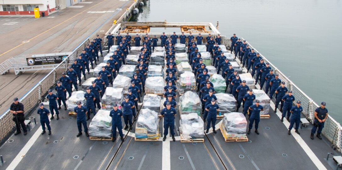 U.S. Coast Guardsmen aboard the USCGC Waesche (WMSL 751), homported in Alameda, California, stand alongside approximately 18 tons of cocaine in San Diego on June 15, 2017. The narcotics were seized during 18 separate interdictions in the Eastern Pacific Ocean from March through June 2017. (U.S. Coast Guard photo by Petty Officer 3rd Class Davonte Marrow)