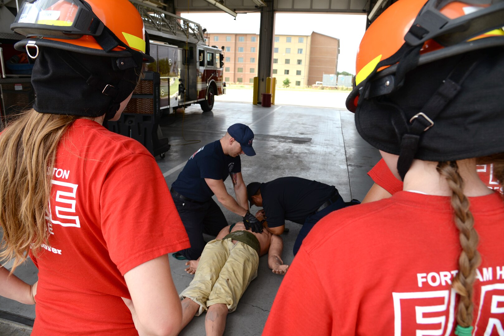 Fort Sam Houston firefighters Aaron Gaunt (left) and Randy Simeon (right) demonstrate chest compressions to students enrolled in the installation’s Fire Explorer program at the JBSA-Fort Sam Houston Fire Station June 14. The two-week program allows students to experience some of what it takes to become a firefighter.