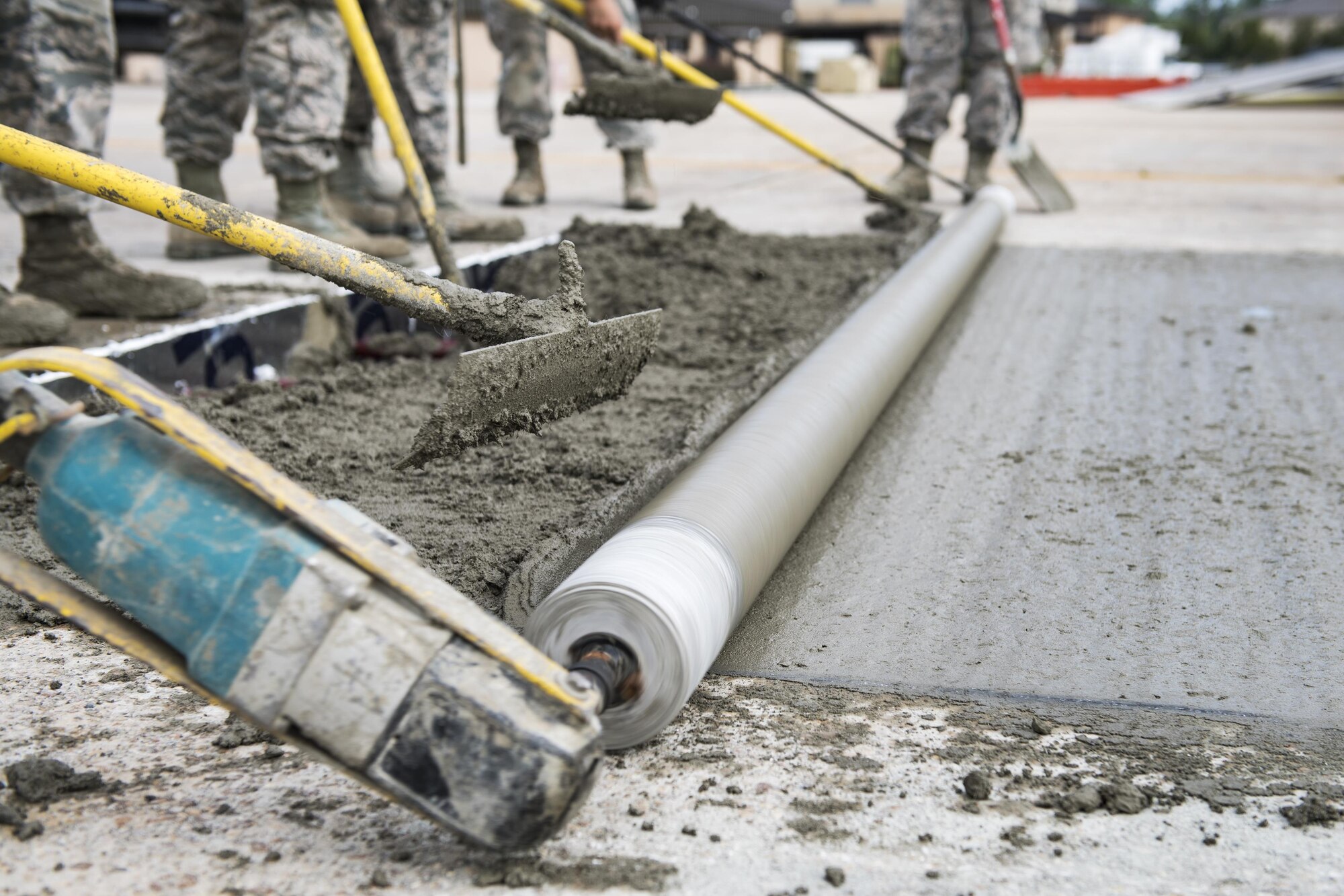 Students use various concrete leveling tools to finish a new patch of cement during a Pavements Maintenance, Inspection and Repair course, June 15, 2017, at Moody Air Force Base, Ga. Every year, training managers at the major command level across the Air Force pick multiple bases across the Air Force to host the course, and this year Moody hosted one from June 5-16. (U.S. Air Force photo by Senior Airman Janiqua P. Robinson)